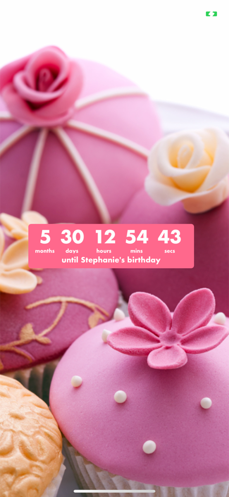 Birthday countdown timer displaying time remaining until Stephanie's birthday over a background of pink cupcakes with flowers