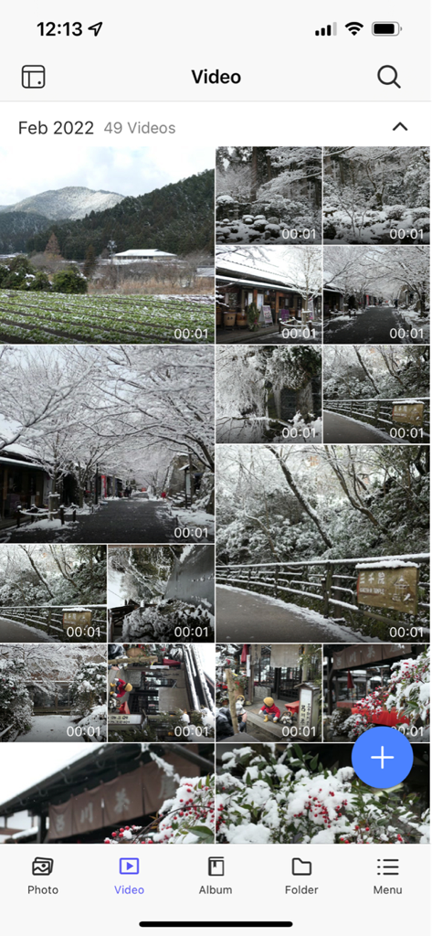 QuMagie mobile app video gallery showing a grid of personal videos organized by date