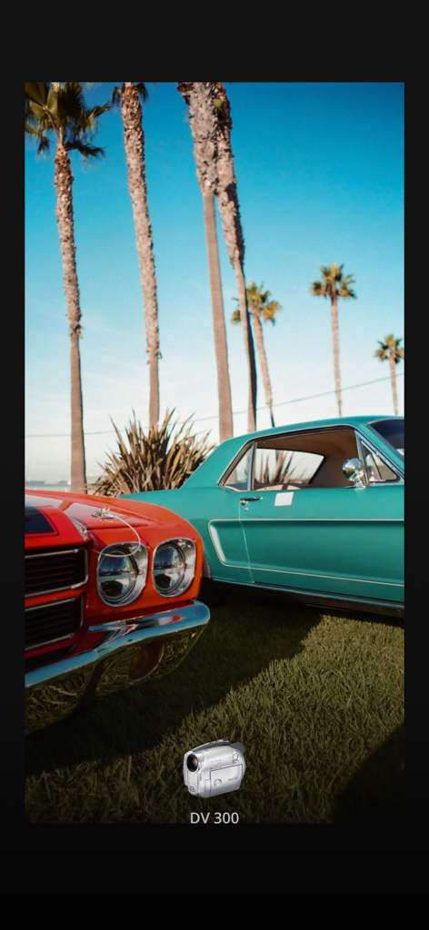 Cinematic vintage film photo of classic cars and palm trees using the Locca app filter.