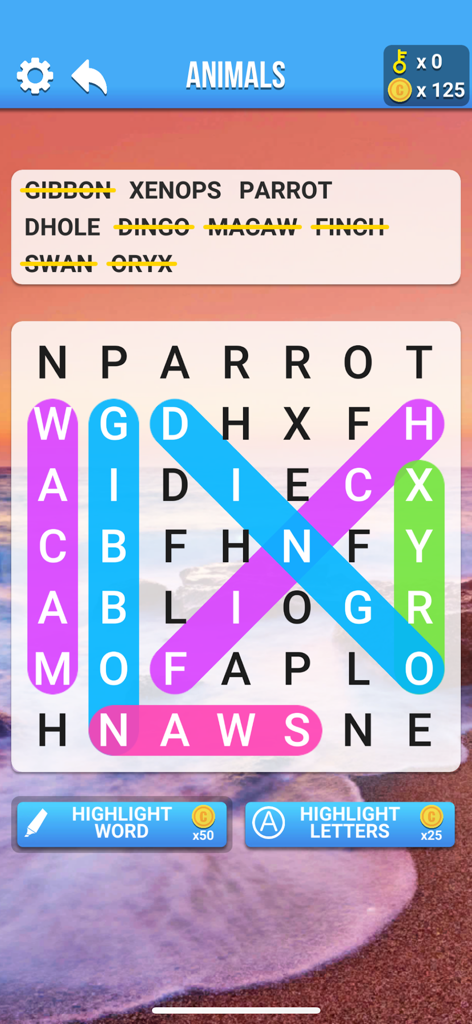 A word search puzzle game screen featuring animal names and colorful highlighted words over a relaxing beach background