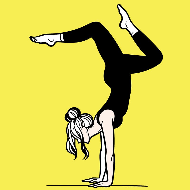 a woman doing a handstand