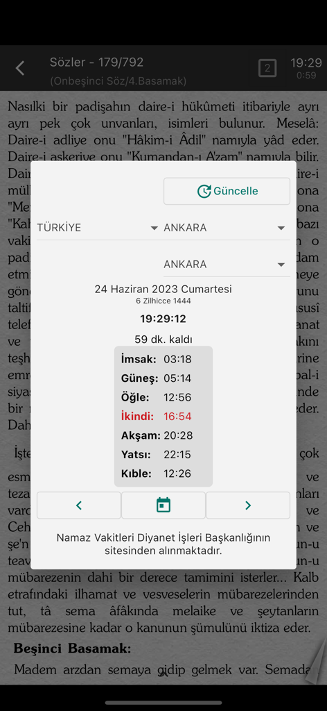 A popup window displaying Muslim prayer times over Turkish text in the Risale-i Nur reading app