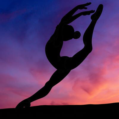 gymnast doing a leap in a leotard with a bent back leg