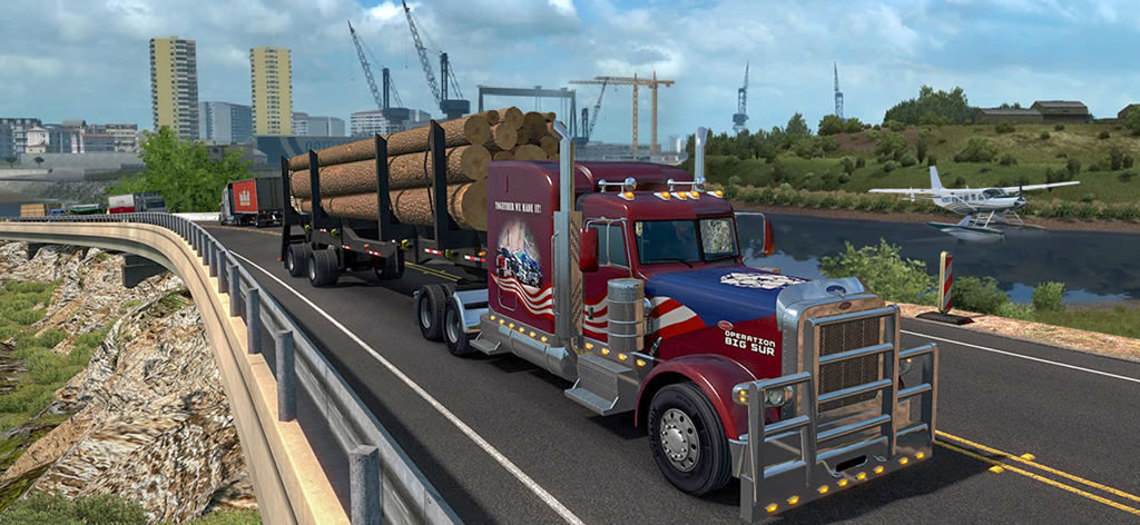 A heavy cargo truck with an American flag livery transporting logs on a bridge.
