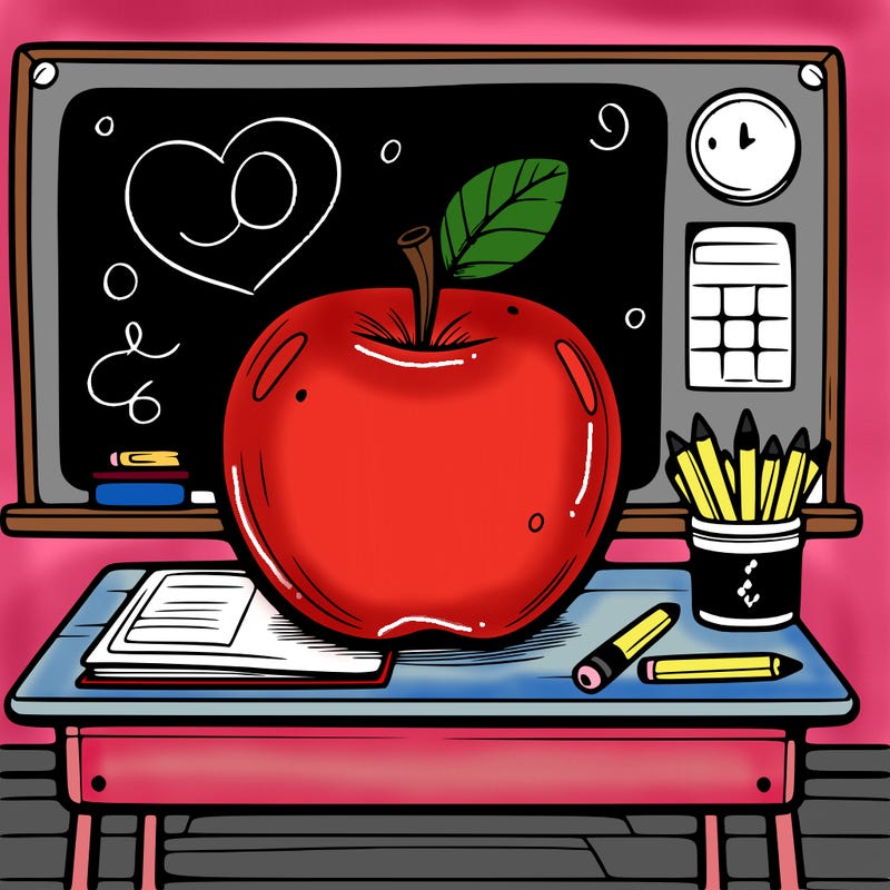 an apple sitting on a teacher’s desk