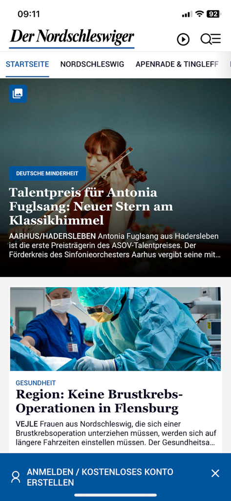 La pantalla de inicio de la aplicación de noticias Der Nordschleswiger mostrando artículos de noticias regionales alemanas.