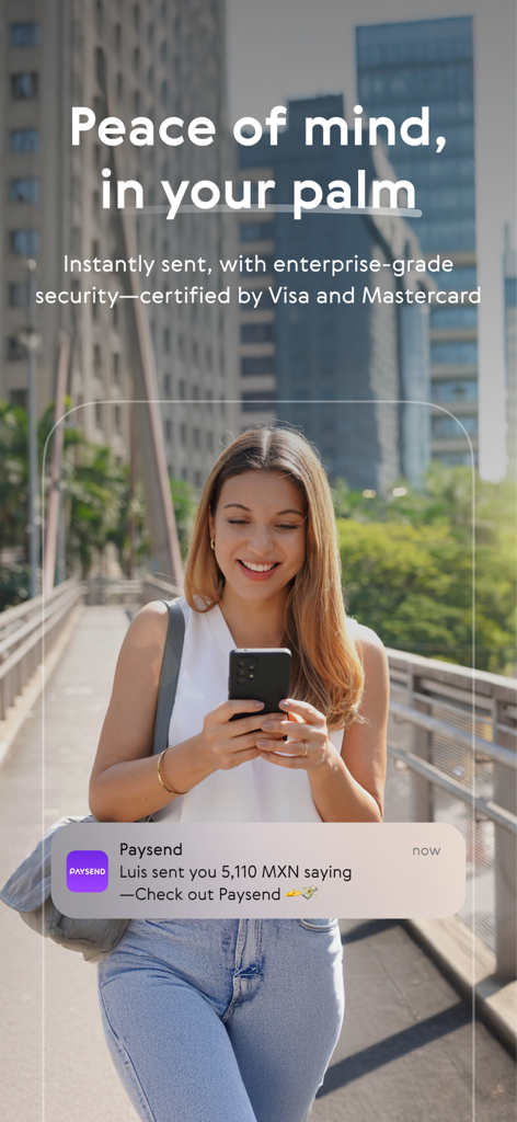 A woman smiling while using the Paysend app on her smartphone to receive a secure international money transfer