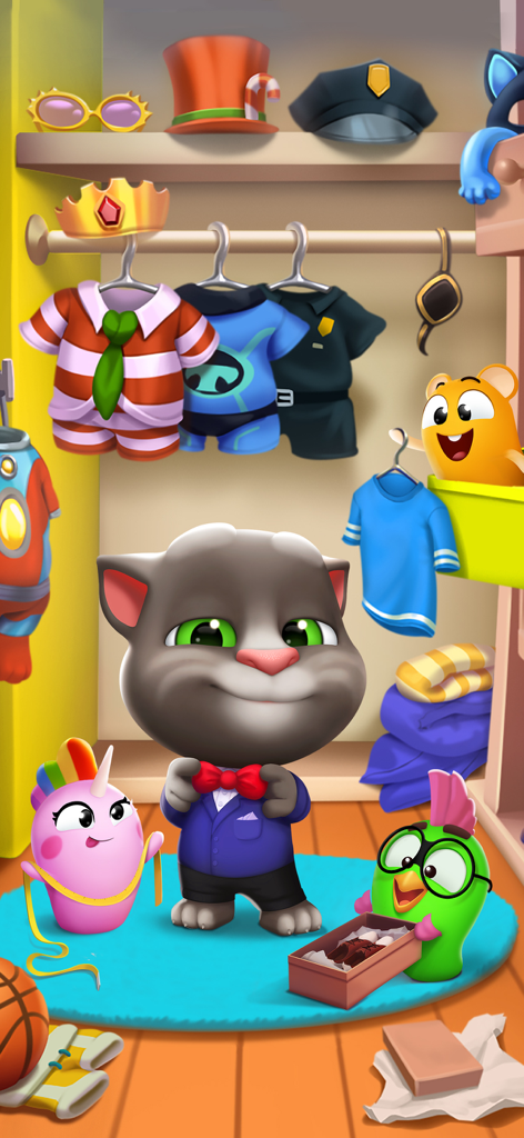Talking Tom in a blue suit and red bowtie inside a colorful closet with various costumes and hats.