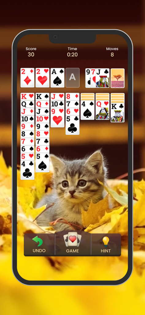 Klondike solitaire card game screen with a cute kitten background