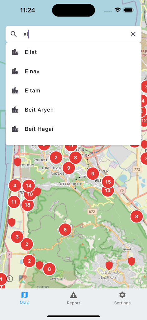 A search screen in the Bomb Shelter Locator app displaying city results over a map with shelter icons.