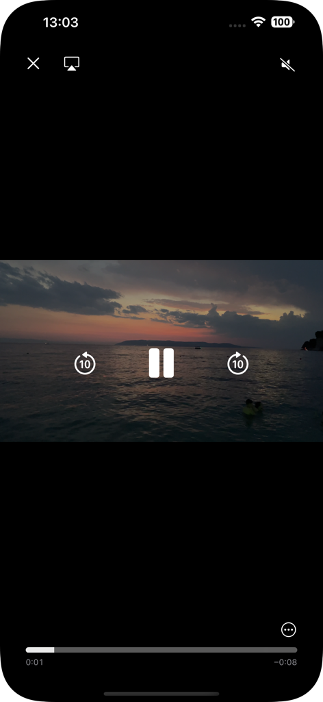 Interface of the video compressor app showing a sunset video preview with playback controls like pause and skip