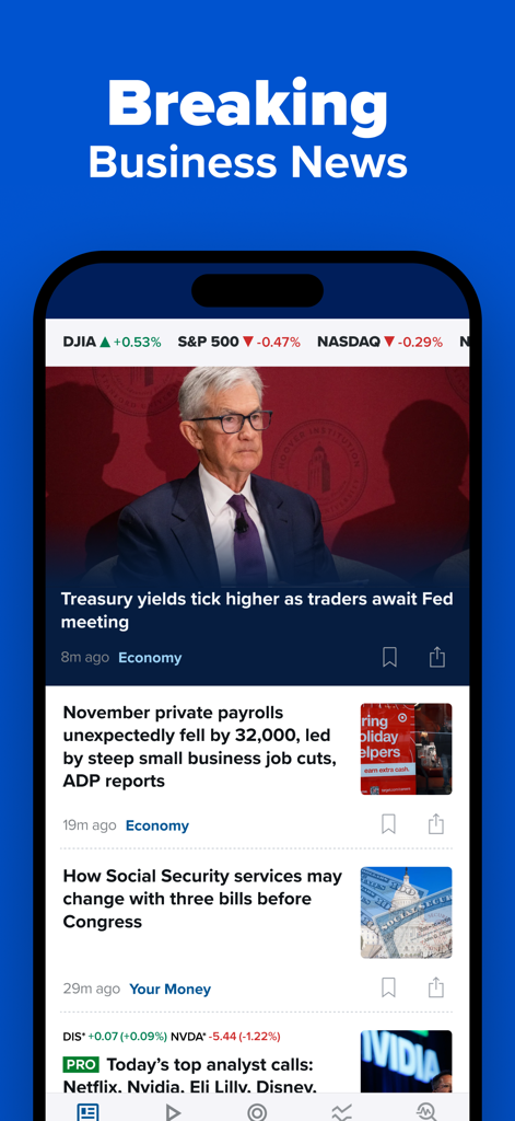 CNBC app interface showing breaking business news stories and real-time stock market indices