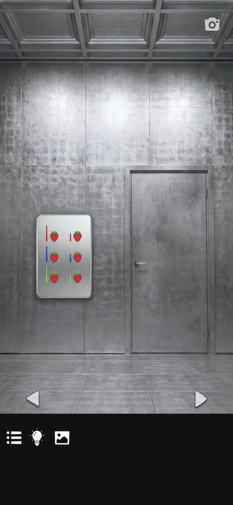 Strawberry puzzle panel on a metallic wall in a cooperative escape game room