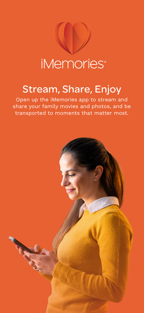 iMemories - A woman smiling while using the iMemories app on her smartphone to view family photos and videos