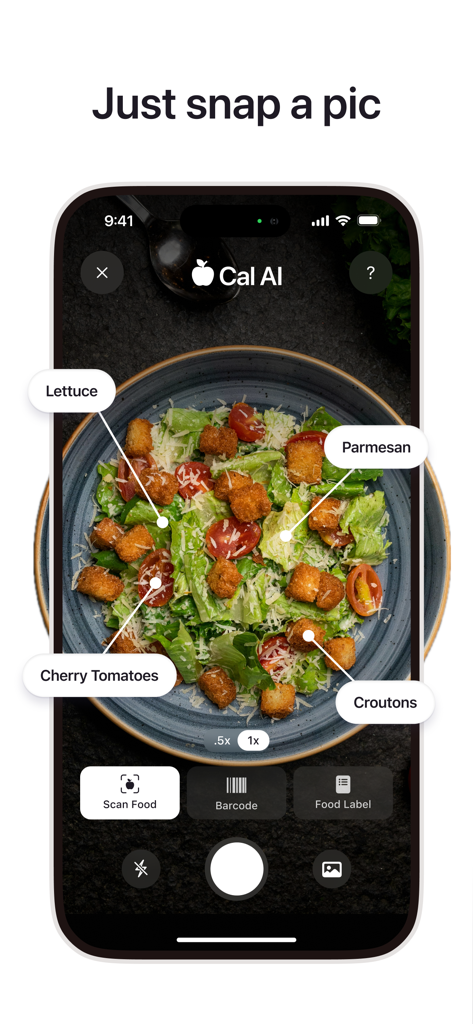 A smartphone showing the Cal AI app identifying ingredients like lettuce and parmesan in a salad using its photo scan feature.
