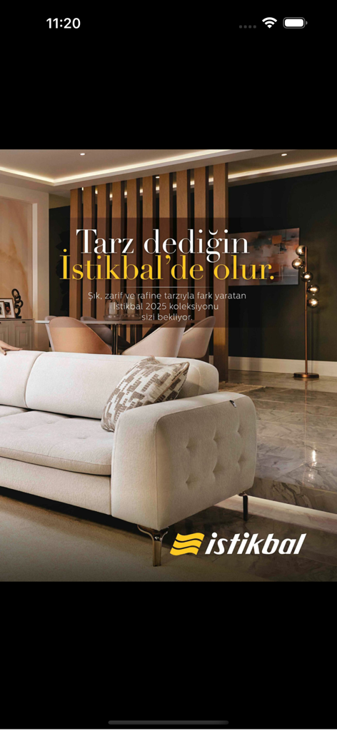 House Beautiful Turkiye - Sophisticated modern living room with a cream sofa and wooden room divider from the Istikbal 2025 collection