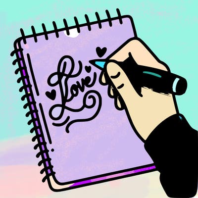 a hand writing “love” in calligraphy on a notebook