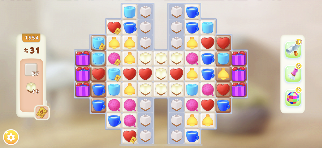 A colorful match-3 puzzle board from the Homematch interior design game featuring home-themed icons and boosters.