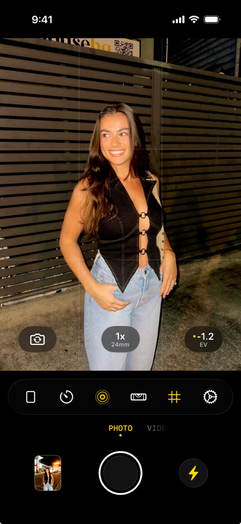 A mobile app interface of flag7x showing a high quality flash photo of a woman in a night setting using G7X camera emulation