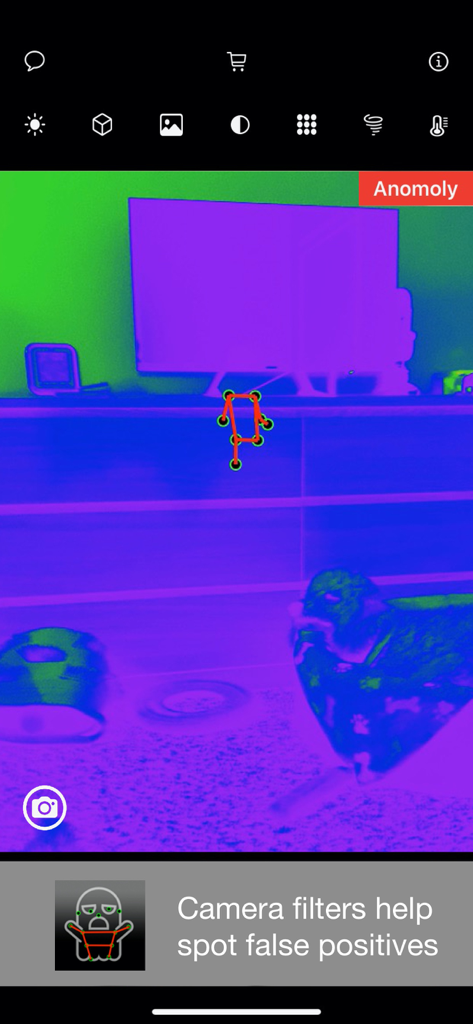Ghost SLS - Screenshot of Ghost SLS app showing a stick figure detected on a TV stand using a thermal-style camera filter to identify anomalies.