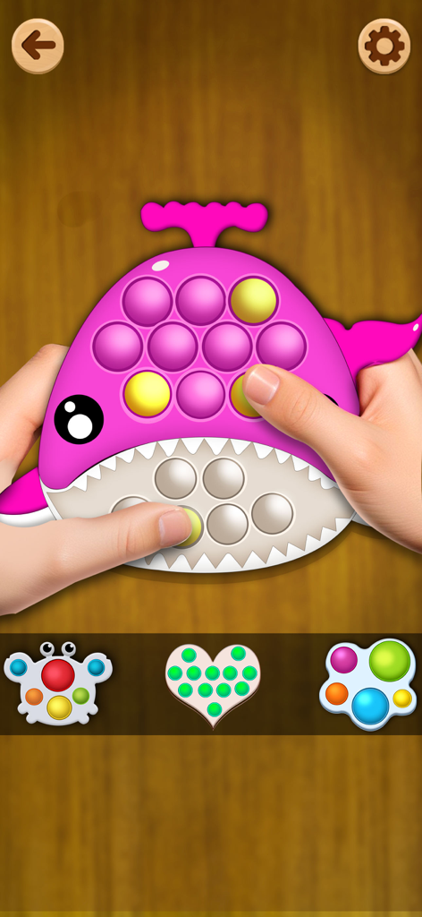 Tidy Fidget ASMR: Antistress - Un juguete antiestrés pop it con forma de ballena rosa siendo jugado en el juego Tidy Fidget ASMR