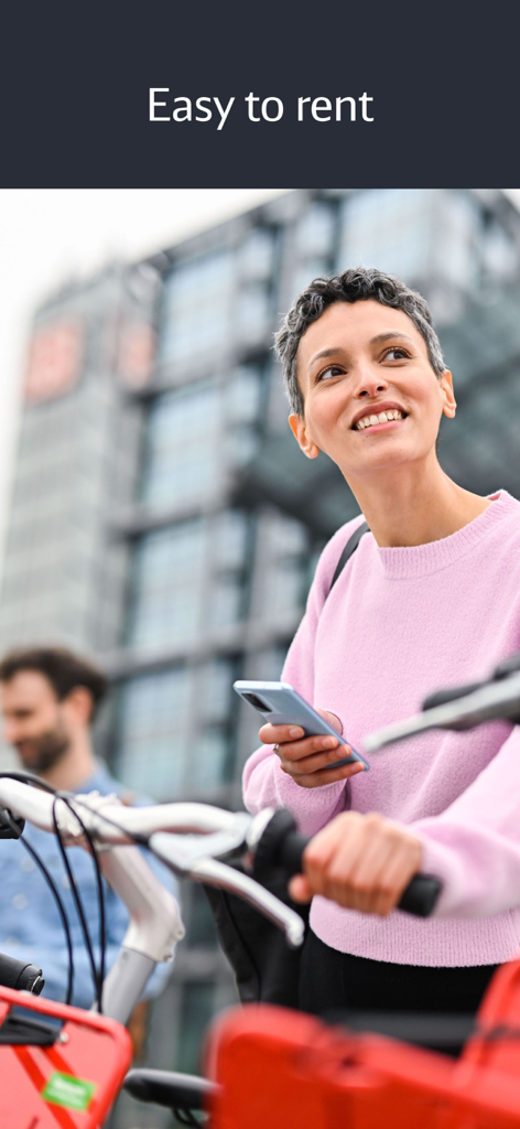 Call a Bike - A woman smiling while holding her smartphone to rent a bike in a German city