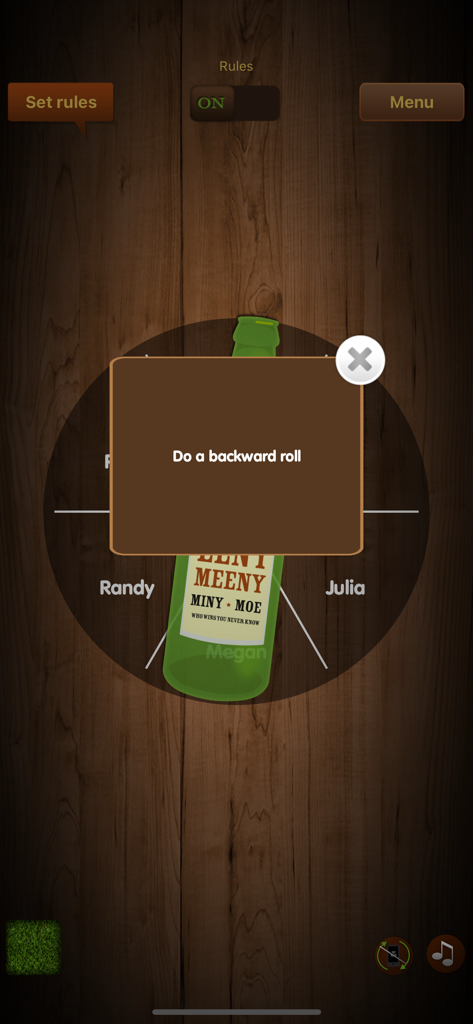 A screenshot of the Spin the Bottle app showing a game task that says Do a backward roll over a virtual bottle and player names.