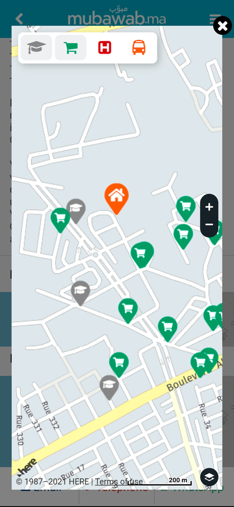 Map view of a property listing in Morocco showing nearby schools and shops on the Mubawab app