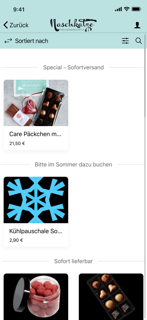 Produktlistungsbildschirm der Naschkatze Münster App mit handgefertigten Schokoladen-Geschenkboxen und Pralinen