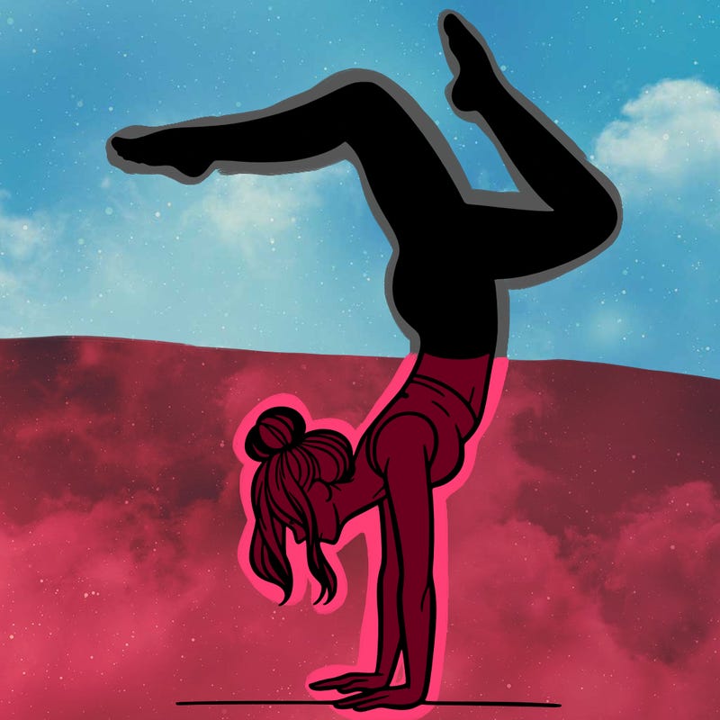 a woman doing a handstand