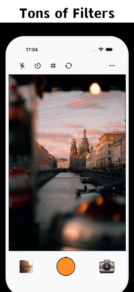 Smartphone screen showing the Daxx Cam app interface with a vintage film filter applied to a scenic city canal and cathedral photo.