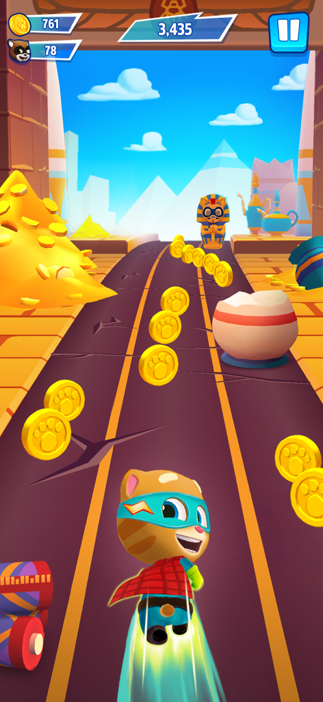 Talking Tom in a superhero costume flying through a desert themed level collecting gold coins in Hero Dash.