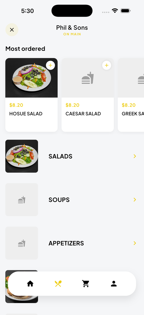 Interfaz del menú de la aplicación móvil Phil and Sons que muestra los artículos más pedidos como ensaladas y categorías de comida que incluyen sopas y aperitivos