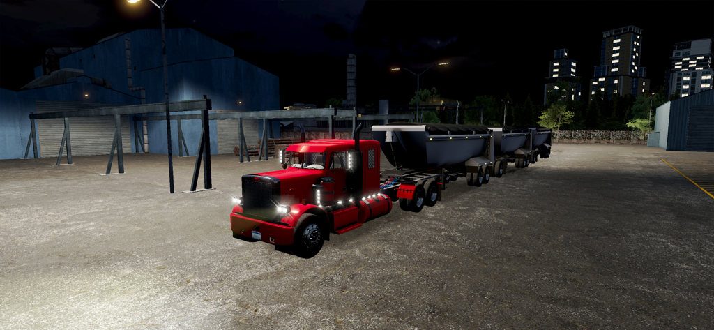 A red semi truck pulling triple trailers at night in an industrial warehouse lot