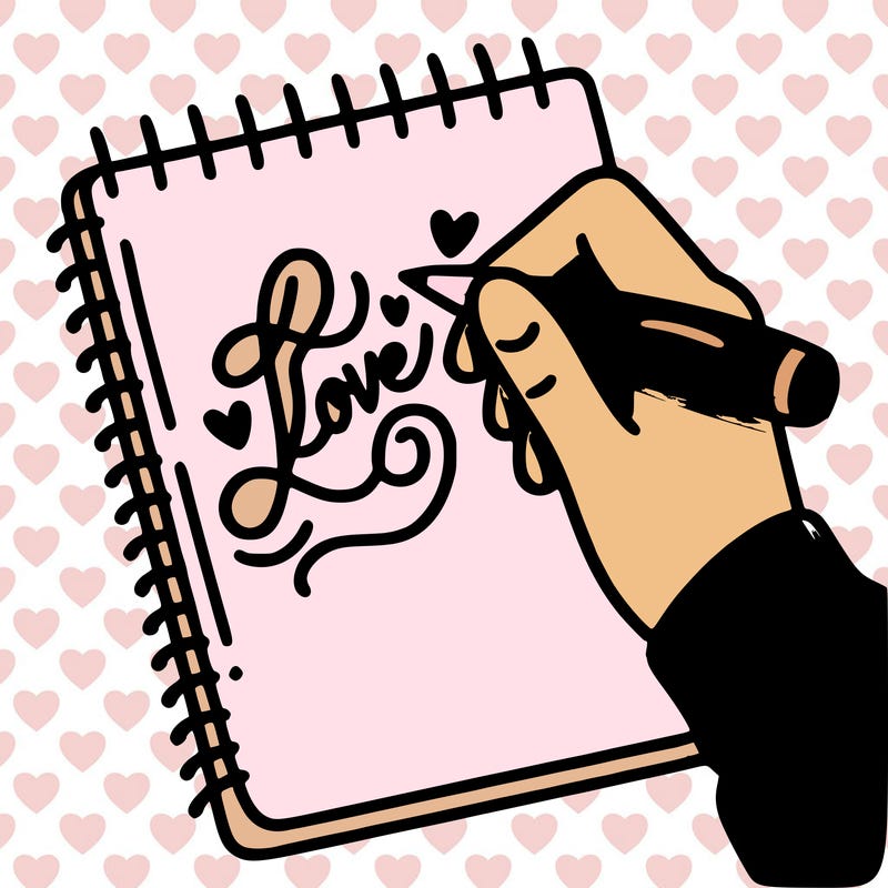 a hand writing “love” in calligraphy on a notebook