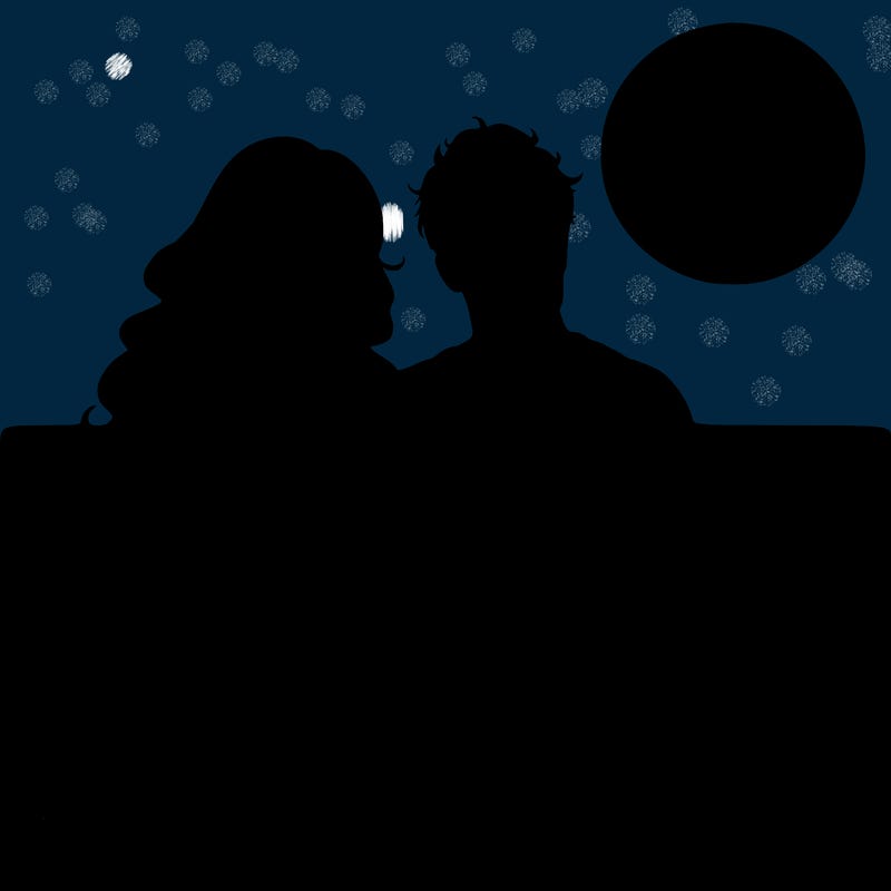 realistic couple on beach sat looking out to sea under the moon woman has long wavy hair man has short hair