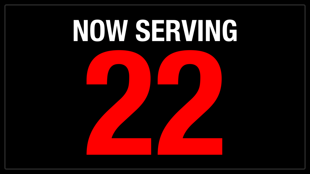 A digital Now Serving counter display showing the number 22 in large red font on a black background.