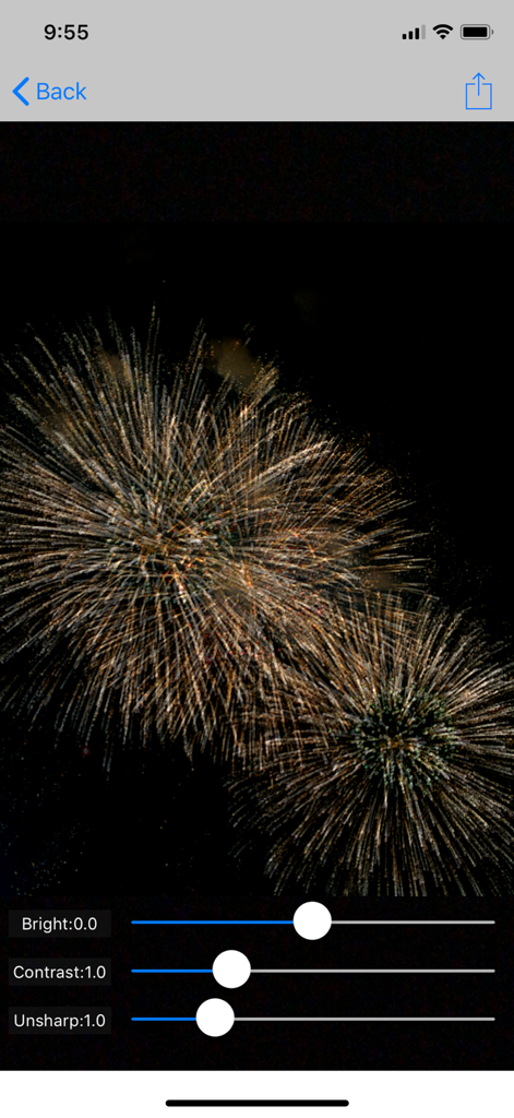 FireWorksBld - FireWorksBld app editing screen showing a golden firework photo with sliders for brightness contrast and unsharpness