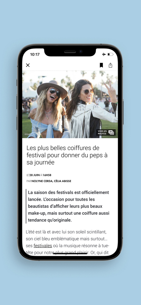 Smartphone screen displaying an ELLE article about the best festival hairstyle trends.