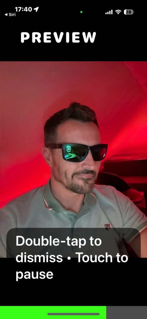 Black Lens - A man wearing sunglasses in a red-lit room shown in the Black Lens app preview screen with a text overlay instructing to double-tap to dismiss or touch to pause.