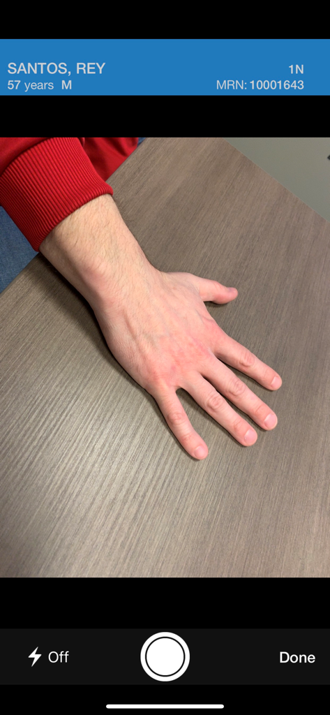 Cerner Camera Capture - Interface of Cerner Camera Capture app showing a patient hand photo with clinical identification details at the top