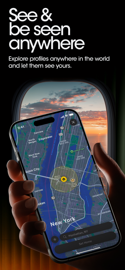 A hand holding a smartphone showing the Grindr app's global explore map over New York City with an airplane window sunset background.