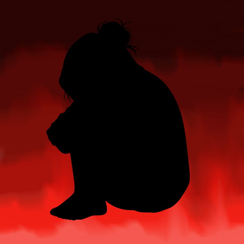 girl crying with hoodie over her hair and hair in bun