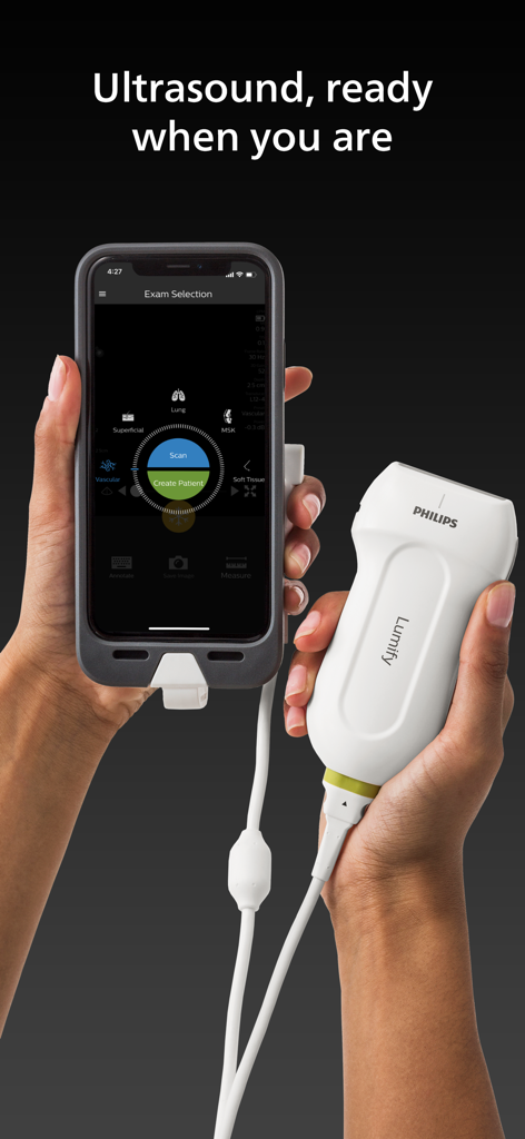 A person holding a Philips Lumify ultrasound transducer connected to a smartphone displaying the medical exam selection interface