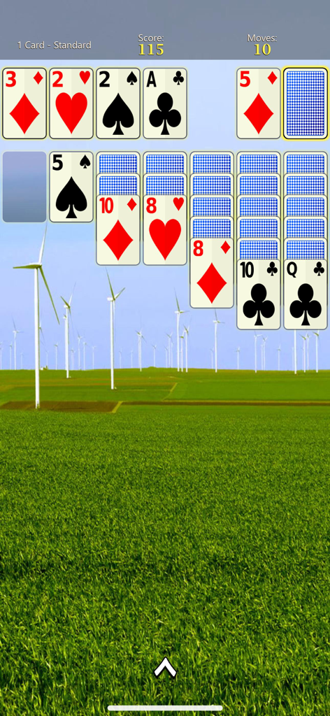 Solitaire Mobile - Solitaire Mobile gameplay featuring large cards and a scenic wind turbine background