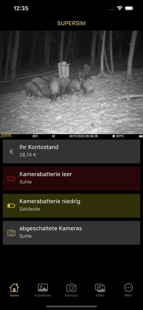 SUPERSIM - SUPERSIM app dashboard displaying a night vision image of wild boars and camera battery status alerts.