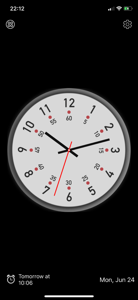 Una esfera de reloj analógica minimalista con una esfera blanca, manecillas de hora y minuto negras y una manecilla de segundo roja sobre un fondo negro