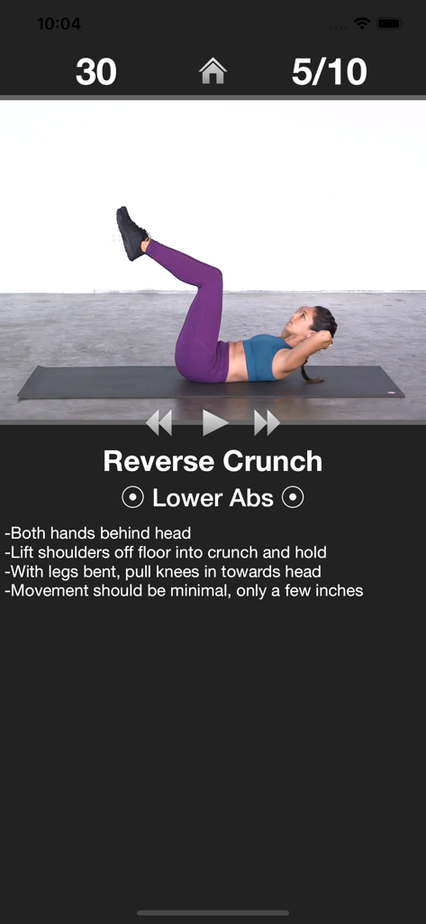 A woman demonstrating a reverse crunch exercise on a yoga mat within the Daily Ab Workout app interface.