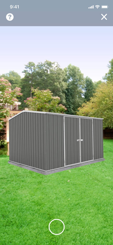 Absco Sheds Assembly App - Augmented reality view of a grey Absco garden shed in a backyard