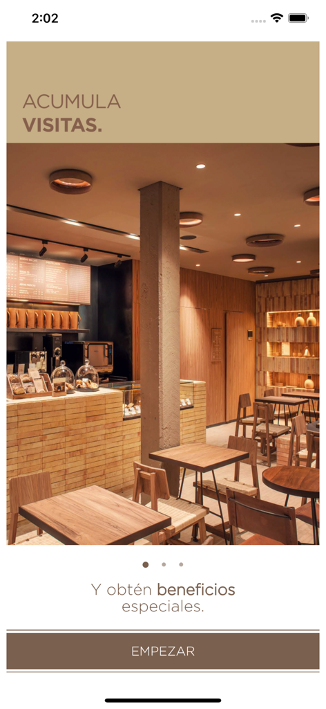 Tierra Garat - Pantalla de bienvenida de la app Tierra Garat con un interior rústico de cafetería e información sobre cómo obtener recompensas